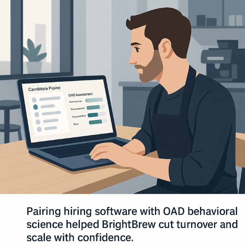A coffee shop manager sits at a laptop in a modern café, reviewing a hiring dashboard that shows a candidate pipeline alongside OAD behavioral assessment insights. Caption reads: “Pairing hiring software with OAD behavioral science helped BrightBrew cut turnover and scale with confidence.”
